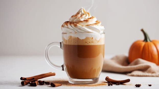 A warm pumpkin spice latte sits elegantly in a clear glass, adorned with whipped cream and a sprinkle of cinnamon, embodying the essence of autumn's comforting flavors and festivities.