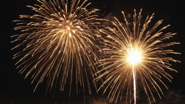 Spectacular golden fireworks explode dynamically against the dark sky, illuminating the night and enchanting the crowd during a festive occasion.