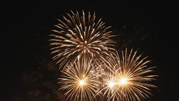 Vibrant golden explosions light up the night, showering the dark sky with brilliant sparks. This festive display captivates onlookers, creating a magical atmosphere of celebration and joy.