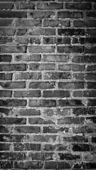 Black and white panorama of old brick wall. Texture of aged masonry with broken brick and peeling plaster. Pattern of loft interior or exterior background. Urban, grunge, industrial, abstract backdrop