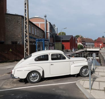 arhus,denmark,03-09-2024:A vintage volvo car parked on a quaint European street, showcasing charming historical architecture in gamle by