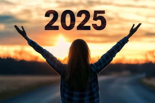 Silhouette of a woman open hand over 2025 sign at sunset celebrating the new year..