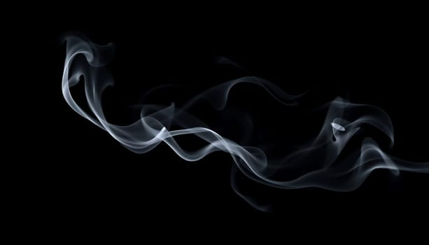 This abstract image features wispy smoke trails in a delicate, swirling pattern against a black background. Perfect for creating a sense of mystery, elegance, or ethereal beauty in your designs. The smoke is captured in a high-resolution photograph with a soft, diffused light, highlighting its flowing and graceful movements. Use this image for website backgrounds, social media posts, graphic design projects, or as a visual element in your creative work.,