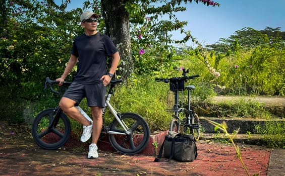 Healthy lifestyle, bicycle sport and exercise, a man in casual sportswear rides a bicycle on a sunny day surrounded by lush greenery, the image captures a sense of relaxation and outdoor adventure, good for health and sport article or content creation