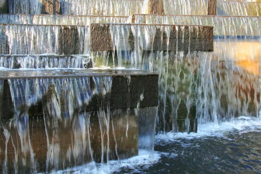 Decorative waterfall on the dam. ..Flowing water on a reservoir dam.