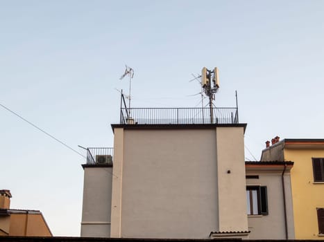 Cremona, Lombardy, Italy October 15th 2024 Telecommunication infrastructure dominates the rooftops of a residential area, showcasing the integration of technology in modern urban living