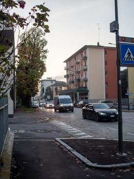 Cremona, Lombardy, Italy October 15th 2024 Vehicles navigating a residential street during twilight hours, highlighting urban mobility and pedestrian safety