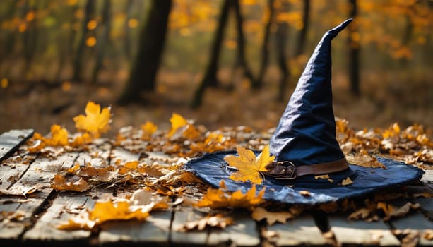A charming witch's hat rests amidst vibrant autumn leaves and small pumpkins, creating an enchanting atmosphere perfect for fall festivities and Halloween celebrations.