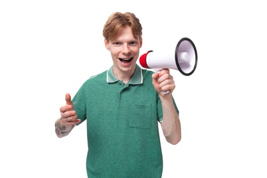young european man with red hair enthusiastically reports the news through a megaphone.