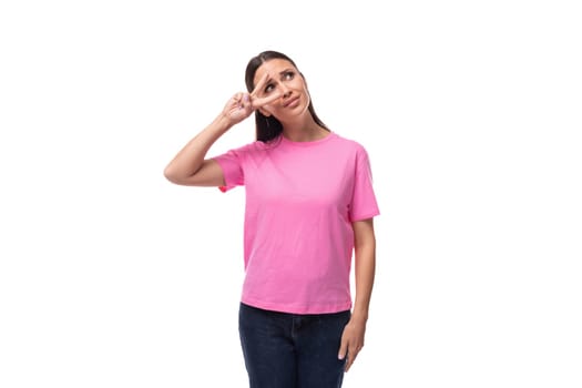 young charismatic good-looking woman with black hair is wearing a pink t-shirt on a white background with copy space.