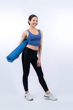 Young attractive asian woman portrait in sportswear with exercising mat. Healthy exercise and workout routine lifestyle concept. Studio shot isolated background. Vigorous