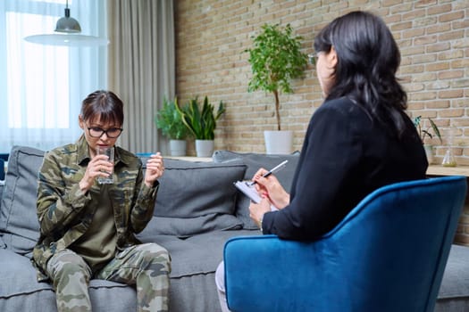 Psychological help support, middle-aged military woman in military clothes talking with professional psychologist psychotherapist. Therapy psychotherapy psychology, ptsd, health care mental treatment