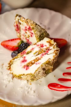 top view of a meringue roll in a section on a white plate close-up.