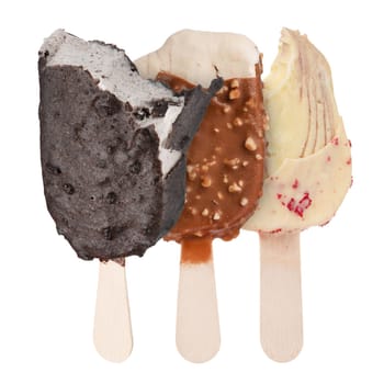 Chocolate ice cream on a stick isolated on a white background. Three portions of bitten ice cream in chocolate glaze of different sizes and different colors for insertion into the project.