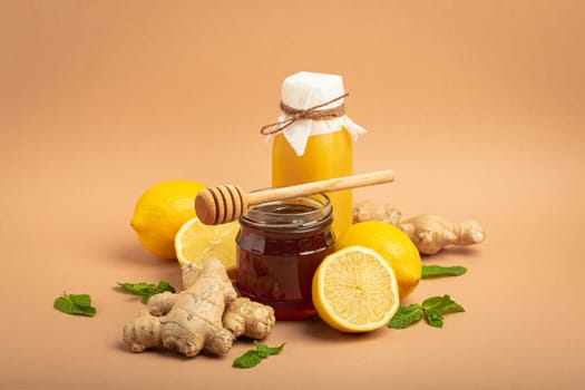 Composition with detox drink, sea buckthorn berries, lemons, mint, ginger, honey in glass jar. Food for immunity stimulation and against flu. Healthy natural remedies to boost immune system.