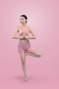 Asian woman in sportswear doing yoga exercise in standing pose on fitness as her workout training routine. Healthy body care and meditation yoga lifestyle in full shot on isolated background. Vigorous