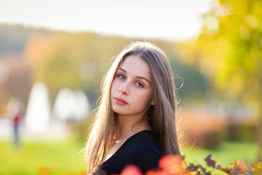 Portrait of a beautiful girl in an autumn park