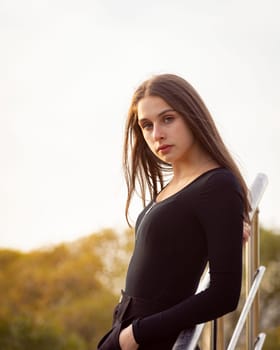 Beautiful girl posing on the steps in an autumn park