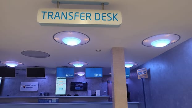 October 26, 2024 Prague Czech Republic, Vaclav Havel Airport, ceiling, lamps, Transfer desk sign in the lobby for tourists. High quality photo