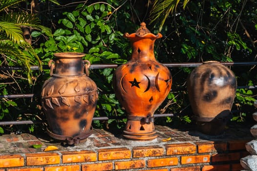 antique clay jugs and vases decorate the garden in Asia in summer