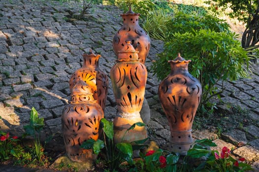 antique clay jugs and vases decorate the garden in Asia in summer