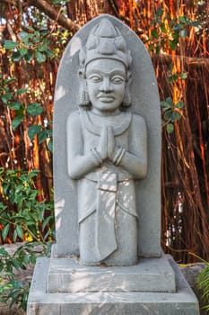 Buddhist statue of deity in park at pagoda at the Cham Towers in Nha Trang in Vietnam