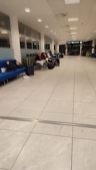October 26, 2024 Prague Czech Republic, Vaclav Havel Airport, people tourists relax in chairs in the lobby waiting for a flight. High quality photo
