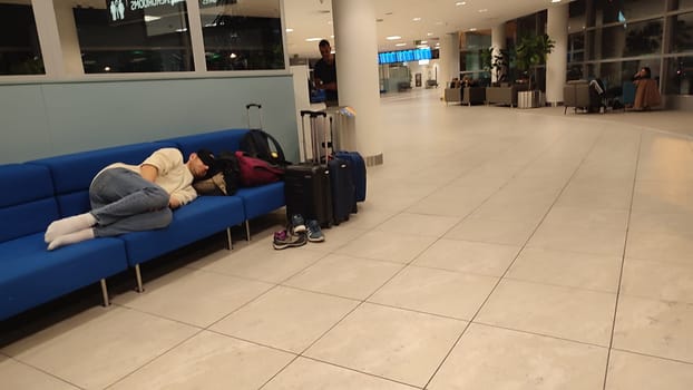 October 26, 2024 Prague Czech Republic, Vaclav Havel Airport, people tourists relax in chairs in the lobby waiting for a flight. High quality photo