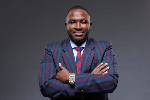 Portrait of handsome African American male businessman on gray background, stylish manager, office worker
