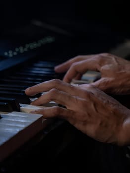 High quality photo. Playing piano. Hands push the key
