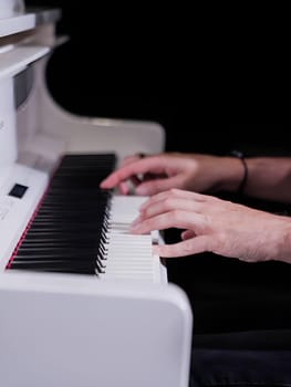 High quality photo. Playing piano. Hands push the key