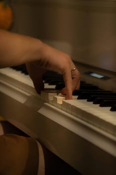 High quality photo. Playing piano. Hands push the key