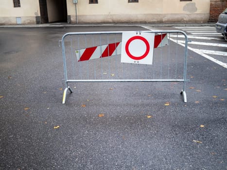 Cremona, Lombardy, Italy October 15th 2024 Metal barrier blocking access to a road, featuring a no entry sign and red and white stripes, indicating restricted access