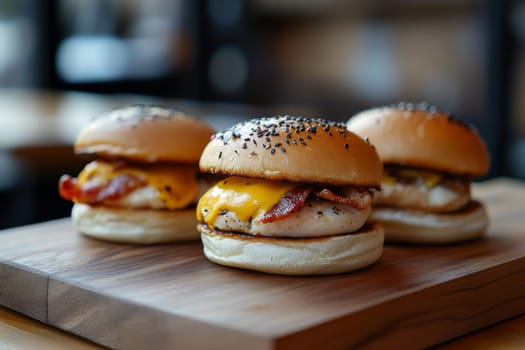 Three juicy tasty hamburgers lie on a wooden table in a bar or cafe. High quality photo
