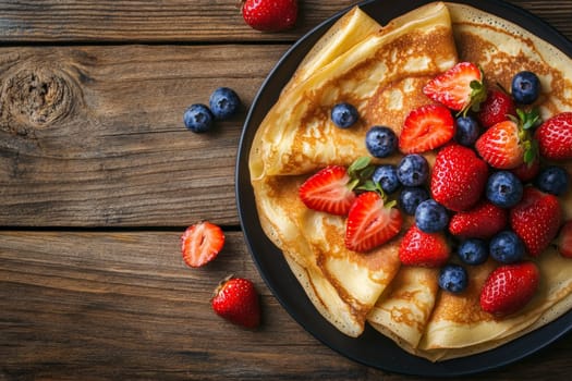 Hot delicious pancakes decorated with blueberries and strawberries. High quality photo