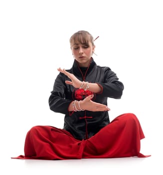 Woman wearing traditional chinese clothes practicing wushu isolated shot on white background