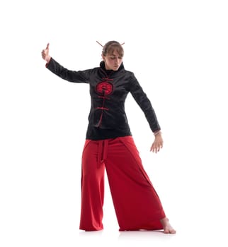 Woman wearing traditional chinese clothes practicing wushu isolated full-length shot on white background