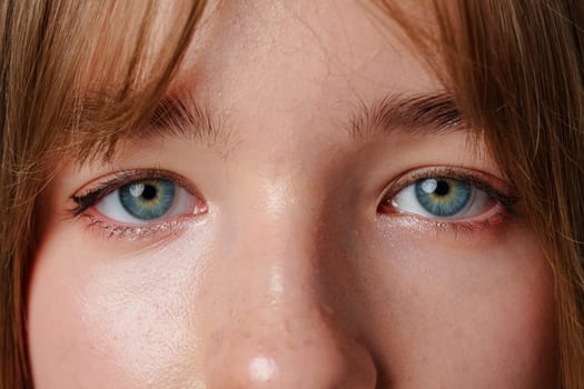 Close-up portrait of a young person with natural skin and calm expression