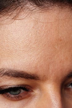 Close-up view of a woman's striking blue eyes with long lashes in studio