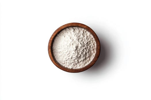 White flour in a wooden bowl. Isolated white background.
