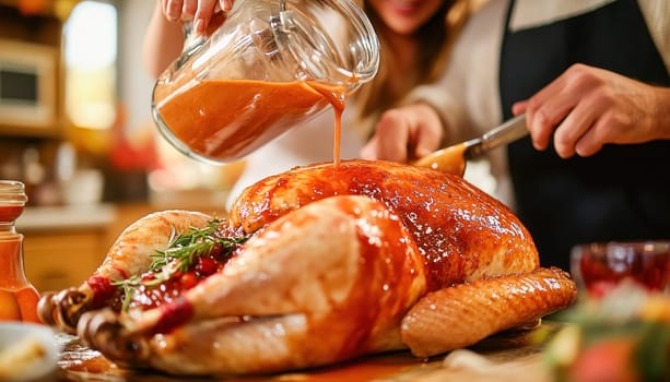 Chefs are pouring sauce on a roasted turkey, garnished with rosemary and cranberries, for a thanksgiving dinner