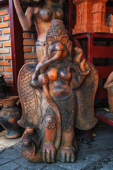 Clay Buddhist figurine statue of a deity in a souvenir shop in Vietnam in Asia