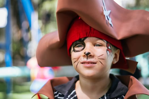 Boy Cat Pirate costume. Halloween party in kindergarten. Aqua makeup painted kids face. Bright festive.