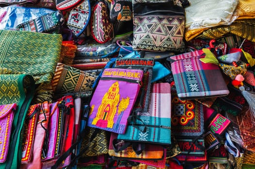 Bags and various textiles on the counter in the market in Vietnam in Asia. Nha Trang, Vietnam - August 8, 2024