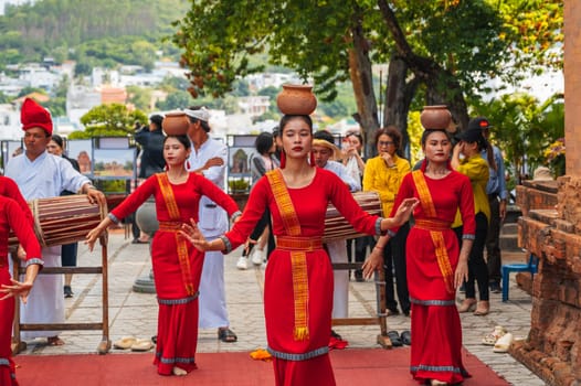 Vietnamese women in traditional red dress dance at the Po Nagar Cham Towers in Nha Trang in Asia. Nha Trang, Vietnam - August 8, 2024