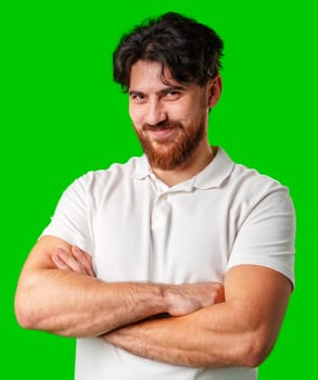 A man with a beard smiles confidently against a bright green background close up