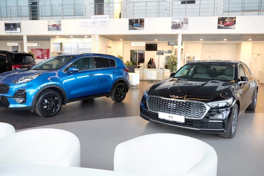 Kazan, Russia - November 25, 2022: Cars in showroom of dealership Kia in Kazan in Russia. Partial focus