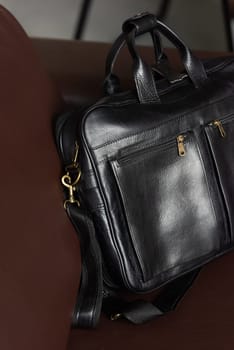 black briefcase on a brown couch