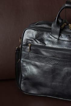 black briefcase on a brown couch