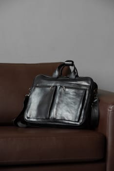 black briefcase on a brown couch